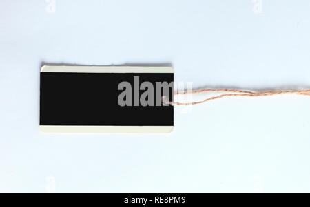 blank decorative tag made of cardboard on a white Stock Photo