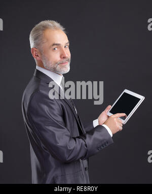 modern businessman using digital tablet.isolated on black background Stock Photo