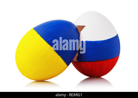 Split in Orthodoxy. Two Easter eggs, painted in the colors of the flags of Russia and Ukraine, isolated on a white background Stock Photo