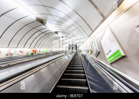 London, UK - June 26, 2018: People riding escalator up and down standing in Underground tube metro in Pimlico Victoria area of city through tunnel Stock Photo