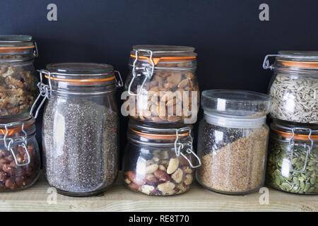 Nuts and seeds in glass jars. Stock Photo