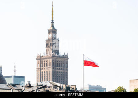 Warsaw, Poland - August 23, 2018: Downtown modern cityscape with red Polish flag waving by Palace of Culture and Sciences building skyscraper Stock Photo