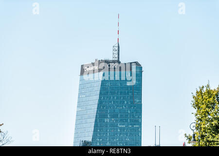 Warsaw, Poland - August 23, 2018: Downtown modern cityscape with closeup of blue glass skyscraper Deloitte Q22 office sign Stock Photo