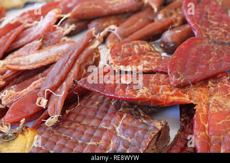 Pieces of snacks made from salted pressed dried fish caviar are on the counter of the store. South of Ukraine Stock Photo