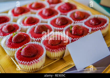 Strawberry cupcates desserts on a tray ready to eat. Stock Photo