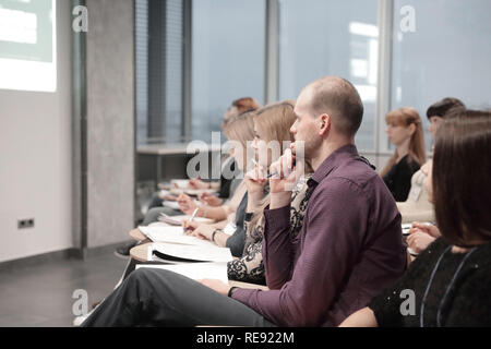 Concentrated young business people listening report about company Stock Photo
