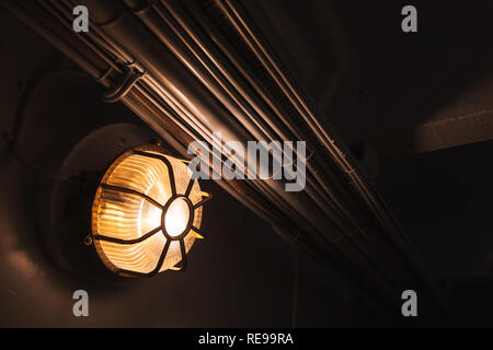 Industrial round light glowing in dark, photo with selective focus and shallow DOF Stock Photo