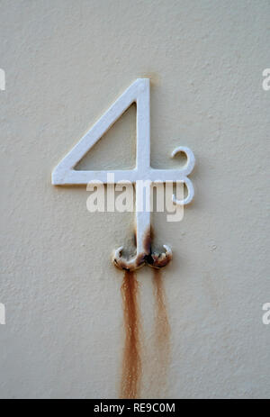 A Close Up Of A Metal Number Four Door Number Painted White And Going Rusty Stock Photo