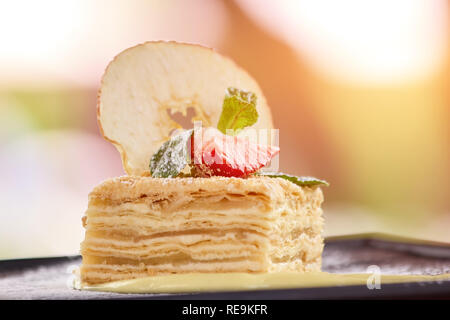 Decorated piece of cake, close up. Cake with many layers. Stock Photo