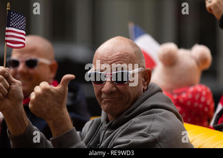 Houston, Texas, USA - November 11, 2018: The American Heroes Parade, Man giving thumbs up and waving the american flag during the parade Stock Photo