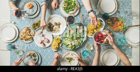 Mediterranean style dinner with various snacks and drinks, wide composition Stock Photo