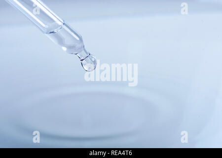 waterdrop with little waves from a pipette Stock Photo