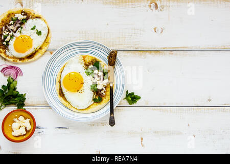 Corn tortilla with fried egg on plate flat lay Stock Photo