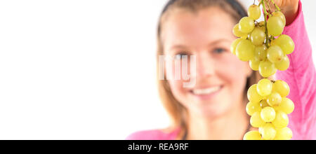 Blond woman holding ripe grapes, white background Stock Photo