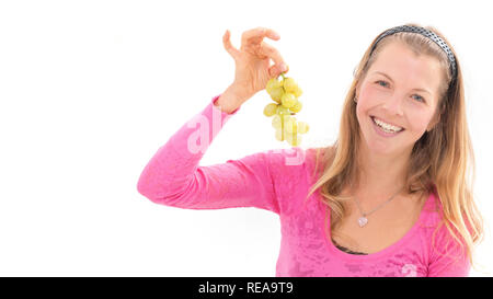 Blond woman holding ripe grapes, white background Stock Photo