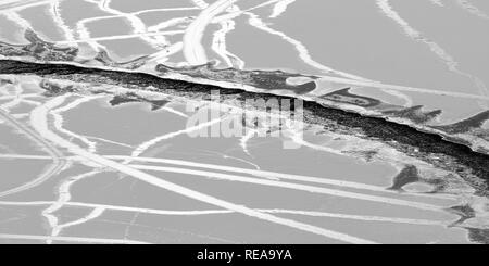 Tracks - Gaps and cracks form in thin surface ice on Emerald Bay. Lake Tahoe, California, USA Stock Photo