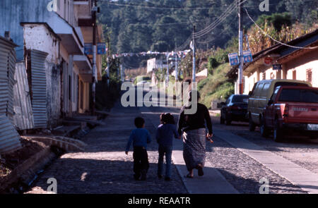 An indigenous Kiche Mayan woman walking home with her children, Momostenango Township, Guatemala. Stock Photo