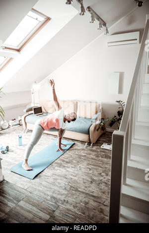 Active woman doing sport in spacious apartment Stock Photo