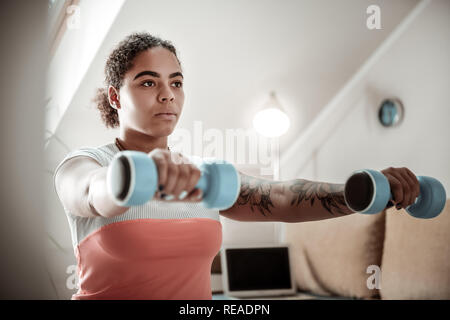 Resolute good-looking serious woman putting forward hand Stock Photo