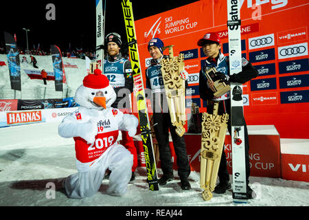 L-R) Robert Johansson (2nd place) of Norway, winner Stefan Kraft of Austria and Yukiya Sato (3rd place) of Japan seen posing for photographers after the individual competition at the FIS World Cup Ski Jumping day three in Zakopane, Poland. Stock Photo