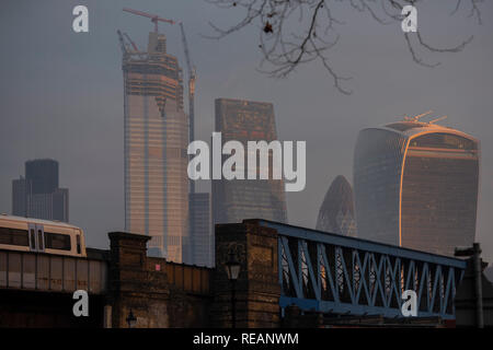 London, UK. 21st January, 2019. The rising sun shines on the tower blocks of the City of London. Credit: Guy Bell/Alamy Live News Stock Photo