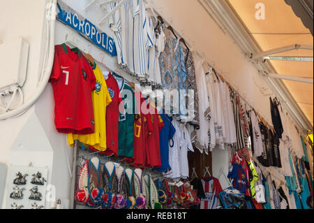 Lindos, Greece. 05/28/2018. Shopping in alley in Lindos Town. Every inch of free wall is old town is used as a display of items for sale to tourists.  Stock Photo