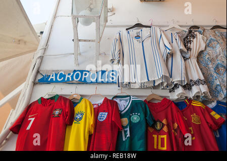 Lindos, Greece. 05/28/2018. Shopping in alley in Lindos Town. Every inch of free wall is old town is used as a display of items for sale to tourists.  Stock Photo