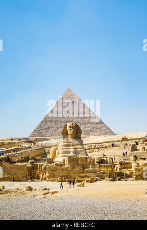 The iconic monumental sculpture, the Great Sphinx of Giza with the Pyramid of Khafre, one of the Great Pyramids, behind, Giza Plateau, Cairo, Egypt Stock Photo