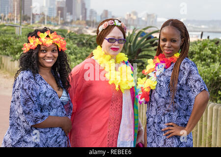 Durban, South Africa - January 06th, 2019: Three women, two blacks and one white celebrating together in the waterfront of Durban, South Africa. Stock Photo