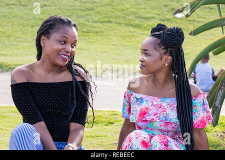 Durban, South Africa - January 06th, 2019: Portrait of two black south african women with braids and tooth grillz in Durban, South Africa. Stock Photo