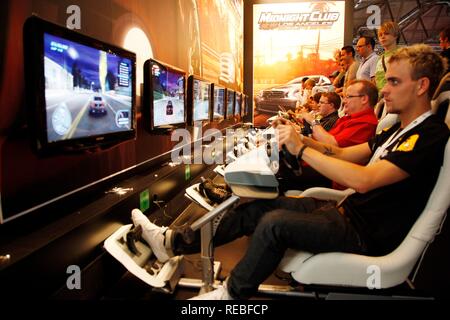 Driving simulator, car racing games, driving games at the Entertainment Area of the Gamescom, the world's largest fair for Stock Photo