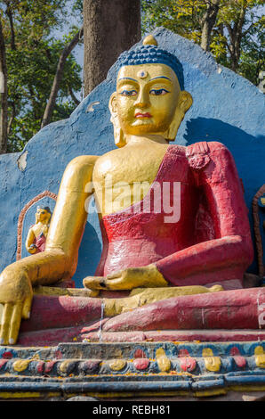 Golden Buddha statue at the base of Swayambhunath Stupa, also known as the Monkey Temple, Kathmandu, Nepal Stock Photo