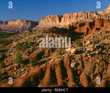 USA, Utah, Capitol Reef National Park, Evening light on rugged cliffs which form the western face of the Waterpocket Fold, view north near Slickrock D Stock Photo