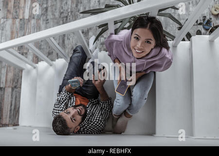 Modern young couple shopping online using their phones Stock Photo