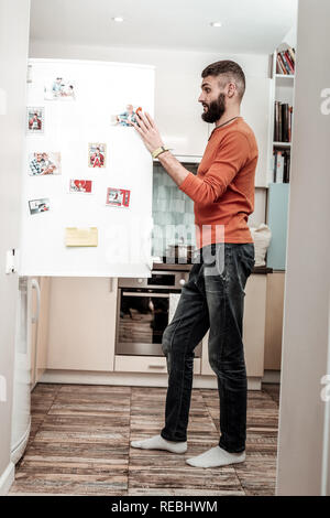 Husband feeling surprised seeing no cooked dinner in refrigerator Stock Photo