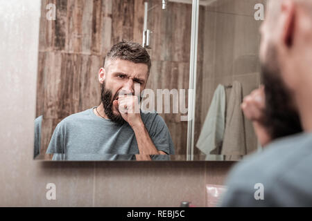 Businessman yawning while feeling sleepy in the morning Stock Photo