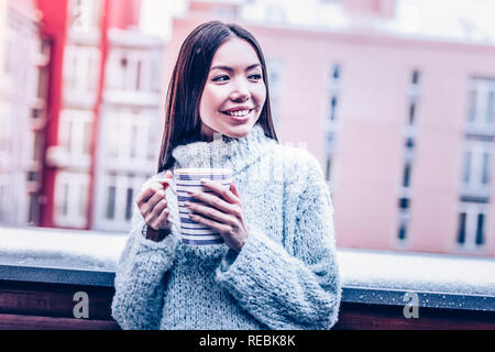 Delighted positive woman standing on the balcony Stock Photo