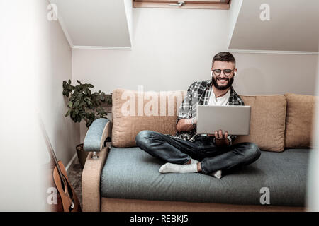 Delighted nice man making a video call Stock Photo