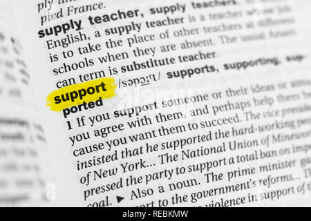 Highlighted English word 'support' and its definition at the dictionary. Stock Photo