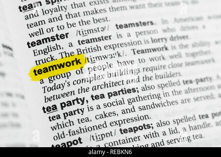 Highlighted English word 'teamwork' and its definition at the dictionary. Stock Photo