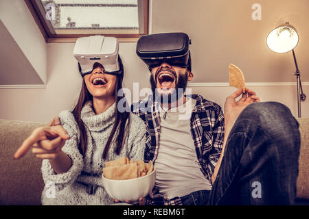 Joyful excited young couple using virtual technology Stock Photo