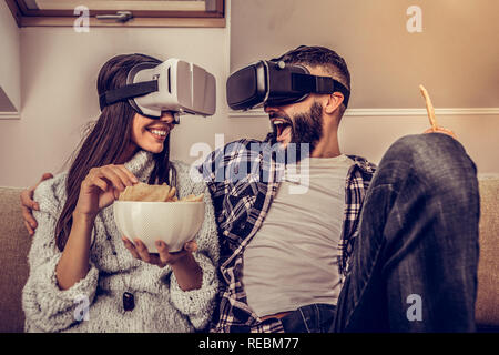 Delighted positive couple using latest digital technologies Stock Photo