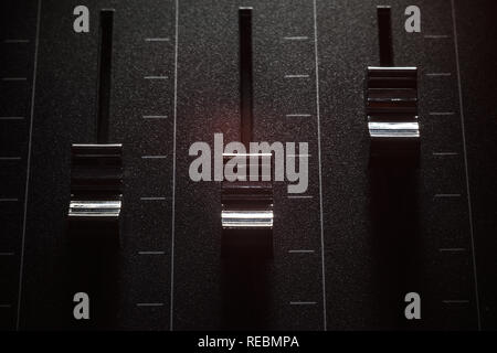 Details of faders of a mixing console, closeup view. Stock Photo