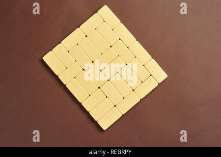 Playing dominoes on a dark background . The concept of the game of dominoes. Close up . Stock Photo