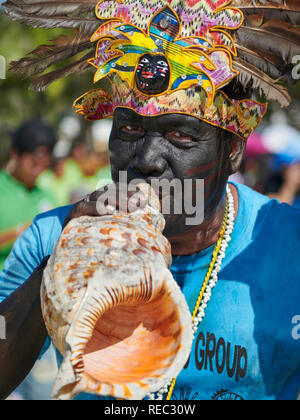 Musician Blowing Shell Stock Photo - Alamy