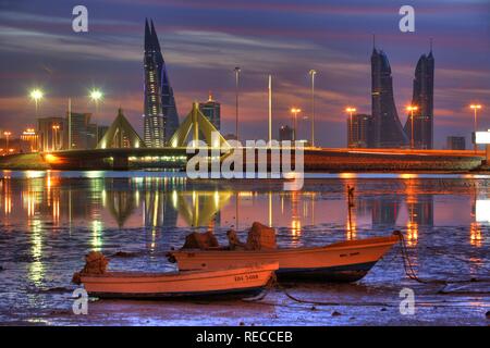 Skyline of the Corniche as seen from King Faisal Highway, Muharraq side, World Trade Center buildings, left, beside the towers Stock Photo