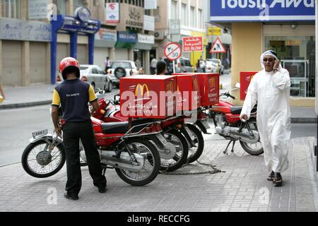 McDonald's restaurant delivery on motorcycle, capital Manama, Kingdom of Bahrain, Persian Gulf Stock Photo
