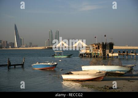 Skyline of the Corniche as seen from King Faisal Highway, Muharraq side, World Trade Center buildings, left, beside the towers Stock Photo