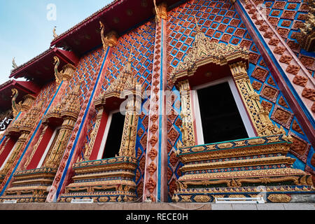 The elaborate windows and wall ornamentation of Wat Phra Nang Sang, Thalang, Phuket, Thailand Stock Photo