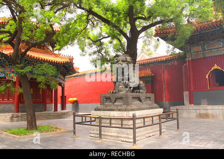 Ancient pavilions and bronze guardian lion statue  in Yonghegong Lama temple (Yonghe Temple, Lama Temple) in Beijing, China Stock Photo